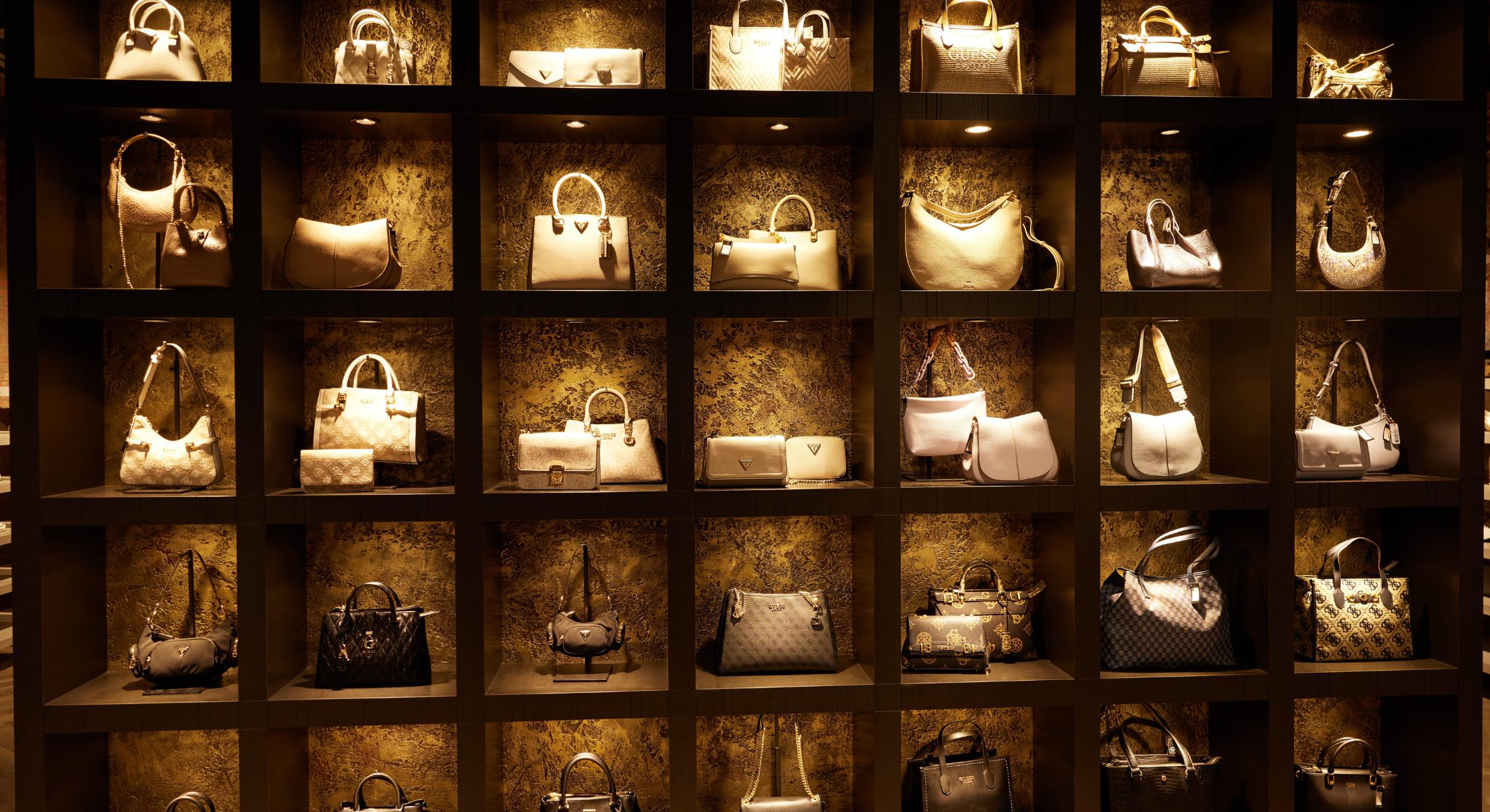 A shelf display at Omoda featuring fashionable handbags.