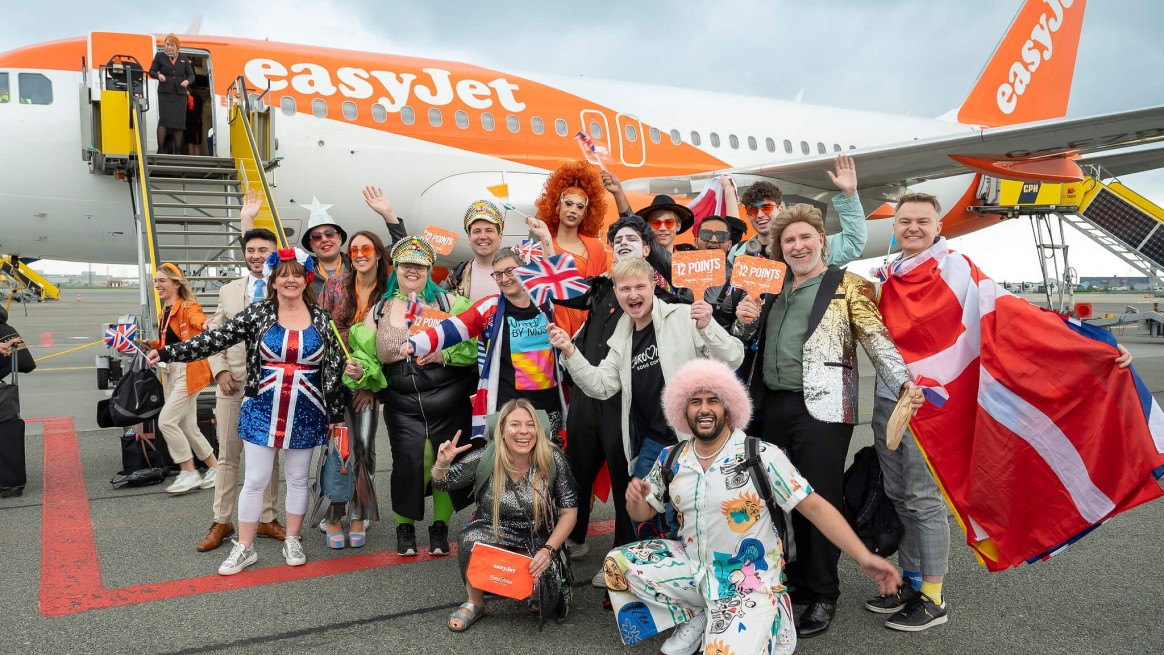 Eurovision fans and EasyJet crew gathered outside of an easyJet plane.