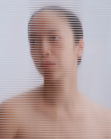 woman through blinds