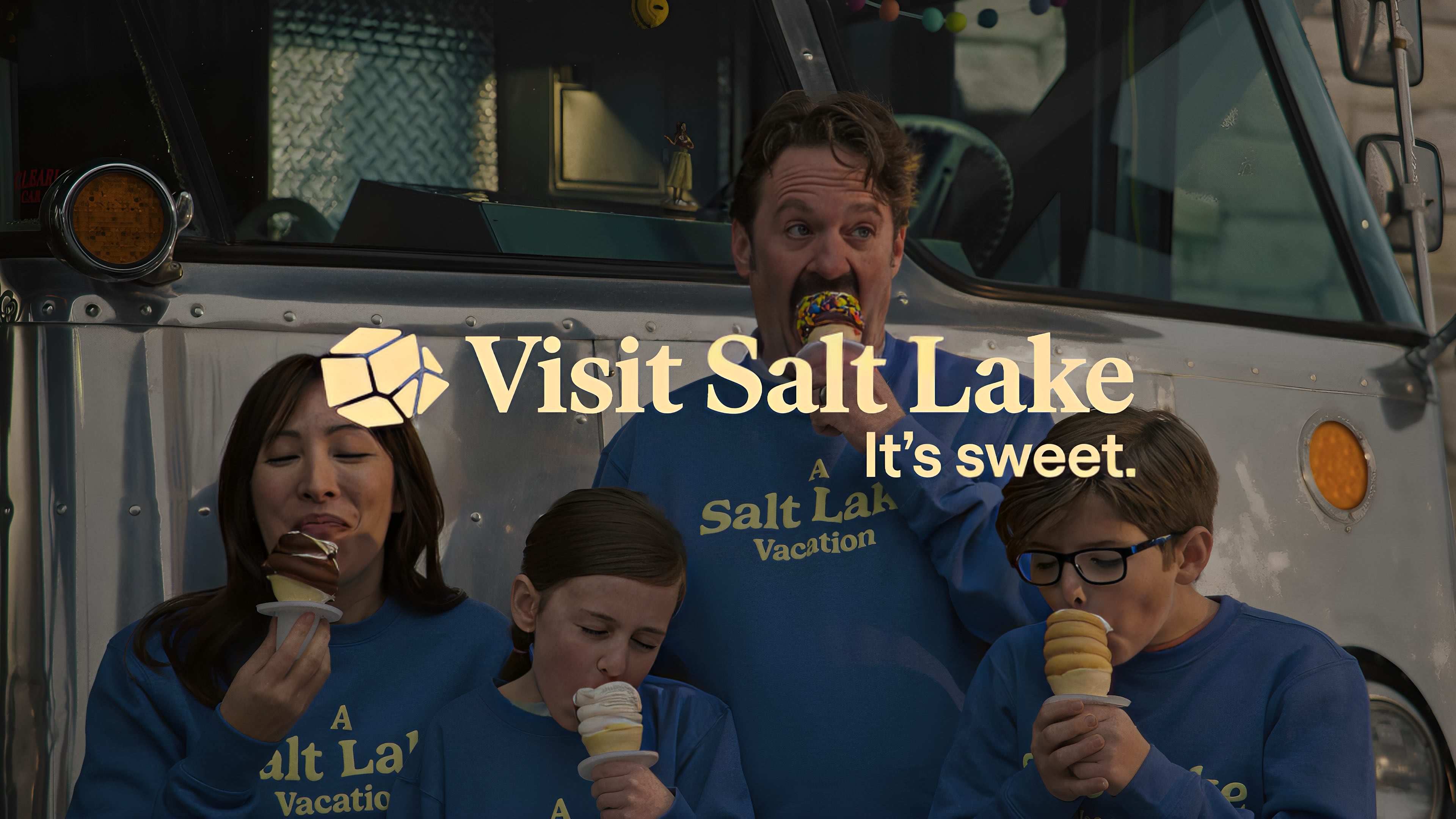 Family eating ice cream with the Visit Salt Lake logo in the centre